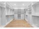 Spacious walk-in closet with custom shelving and drawers, offering ample storage solutions and wood floor at 722 Hillside Ave, Charlotte, NC 28209