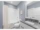 Stylish bathroom with blue walls, a granite vanity, and a tub/shower combination at 831 Naples Dr, Davidson, NC 28036