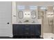 Modern bathroom with double vanities, marble countertops, and a tiled glass-enclosed shower for a spa-like experience at 831 Naples Dr, Davidson, NC 28036