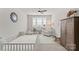 Bright Bedroom with a white crib, rocking chair, and decorative bookshelf at 831 Naples Dr, Davidson, NC 28036