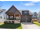Charming home with a two-car garage, inviting front porch, landscaped yard, and craftsman style architecture at 831 Naples Dr, Davidson, NC 28036