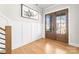 Bright foyer featuring double wooden doors, hardwood floors, and modern wainscoting at 831 Naples Dr, Davidson, NC 28036