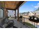 Inviting front porch with wood ceiling, stone floor, black railings, and serene neighborhood views at 831 Naples Dr, Davidson, NC 28036