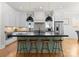 Modern kitchen island featuring stainless steel appliances, stylish counter stools, and pendant lighting at 831 Naples Dr, Davidson, NC 28036