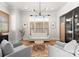 Bright living room featuring plantation shutters, hardwood floors, neutral paint, and modern lighting at 831 Naples Dr, Davidson, NC 28036
