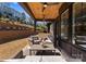 Inviting covered patio with ceiling fans, outdoor kitchen, and comfortable seating for relaxing and entertaining at 831 Naples Dr, Davidson, NC 28036