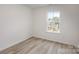 Well-lit bedroom with light-colored flooring and a large window with views of the outdoors at 927 Cathey Rd, Charlotte, NC 28214