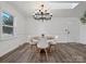 Bright dining room featuring modern chandelier, wood floors, a round table and a skylight for natural light at 1050 Sheraton Way, Rock Hill, SC 29732