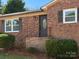 Close-up of the home's brick facade, front door, and manicured landscaping at 1050 Sheraton Way, Rock Hill, SC 29732