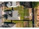 Aerial view of a private backyard with a patio, green lawn, and an outdoor fire pit seating area at 1137 Mckee Farm Ln, Belmont, NC 28012