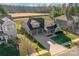 Aerial view of a gray home with a well-manicured lawn, mature trees, and a three-car garage at 1137 Mckee Farm Ln, Belmont, NC 28012