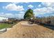 Fenced backyard featuring a fire pit with seating, mature trees, and a landscaped yard at 1137 Mckee Farm Ln, Belmont, NC 28012