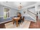 Dining area featuring hardwood floors and crown molding, with views of staircase and backyard at 1137 Mckee Farm Ln, Belmont, NC 28012
