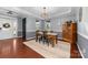 Dining room featuring hardwood floors, a rustic table, and elegant chandelier at 1137 Mckee Farm Ln, Belmont, NC 28012