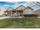 Charming two-story home with a welcoming front porch and well-maintained landscaping at 1137 Mckee Farm Ln, Belmont, NC 28012