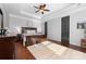 This main bedroom features a tray ceiling, a ceiling fan, and hardwood floors with a decorative rug at 1137 Mckee Farm Ln, Belmont, NC 28012