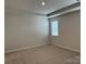 Spacious bedroom with carpeted floor and window with blinds at 1439 Honey Trl, Monroe, NC 28112