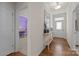 Hallway with hardwood floors and a view of a purple room with a desk and chair at 1503 Ainslie Place Rd, Indian Trail, NC 28079