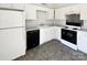 Kitchen with white cabinets, black appliances, and grey flooring at 153 Pattys Pl, Stony Point, NC 28678