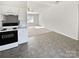 Kitchen with view into living room, white cabinets and flooring at 153 Pattys Pl, Stony Point, NC 28678