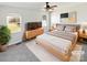 Virtually staged main bedroom with a neutral color scheme and large windows at 153 Pattys Pl, Stony Point, NC 28678