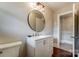 Modern bathroom with round mirror and white vanity at 170 Sherwood Cir, Rock Hill, SC 29730
