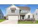 Charming two-story home featuring a mix of stone and siding, attached two-car garage, and well-maintained landscaping at 1713 Wooten Way, Bessemer City, NC 28016