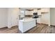Modern kitchen with white cabinets, quartz countertops, and a kitchen island at 1713 Wooten Way, Bessemer City, NC 28016