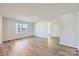 Bright and airy living room with hardwood floors and large window at 1713 Wooten Way, Bessemer City, NC 28016