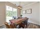 Bright dining room features a sliding glass door to the patio and decorative floral table runner at 19226 Hawk Haven Ln, Charlotte, NC 28278