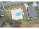 Aerial view of community center, tennis courts, and pool with surrounding green spaces and mature trees at 2008 Surefire Ct, Denver, NC 28037