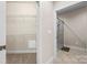 Bathroom featuring tile flooring and a walk-in shower, adjacent to a walk-in closet with wire shelving at 2008 Surefire Ct, Denver, NC 28037