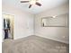 Neutral bedroom featuring carpet, a ceiling fan, and a walk-in closet to the side at 2008 Surefire Ct, Denver, NC 28037