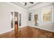 This room has hardwood floors, white trim, a ceiling fan, and glass doors leading to another room at 2008 Surefire Ct, Denver, NC 28037
