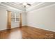 Spacious bedroom boasts hardwood floors, white trim, ceiling fan, and a large window at 2008 Surefire Ct, Denver, NC 28037
