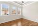 This well-lit bedroom has hardwood floors, white trim, ceiling fan, and a large window at 2008 Surefire Ct, Denver, NC 28037