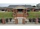 Brick community center with a covered porch, brick steps and iron fence with brick columns and professional landscaping at 2008 Surefire Ct, Denver, NC 28037
