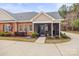 Well-maintained brick home with a screened porch, manicured landscaping and a concrete driveway at 2008 Surefire Ct, Denver, NC 28037