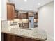 This kitchen features granite countertops, stainless steel appliances, tile backsplash, and custom cabinetry at 2008 Surefire Ct, Denver, NC 28037
