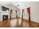 Spacious living room with hardwood floors, fireplace, and abundant natural light at 2008 Surefire Ct, Denver, NC 28037