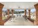 Covered patio with brick columns, ceiling fan, and view of the community pool at 2008 Surefire Ct, Denver, NC 28037
