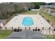 Aerial view of a community pool with a spacious concrete deck and decorative brick columns surrounded by lush landscaping at 2008 Surefire Ct, Denver, NC 28037