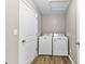 Functional laundry area with washer and dryer hookups and wood look flooring at 205 Kendrick Meadow Ln, Mount Holly, NC 28120