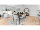 Open concept dining room featuring hardwood floors, modern furniture, and adjoined living room at 2226 Revolution Park Dr, Charlotte, NC 28208