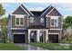 New construction gray home with black garage doors and manicured front lawn under a bright blue sky at 2226 Revolution Park Dr, Charlotte, NC 28208