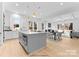 Open-concept living room with hardwood floors, modern furniture, and an adjacent kitchen and dining area at 2226 Revolution Park Dr, Charlotte, NC 28208