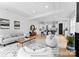 Spacious living room featuring hardwood floors, modern furniture, a fireplace, and an open floor plan at 2226 Revolution Park Dr, Charlotte, NC 28208