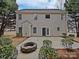 Home's back features a patio and fire pit at 2507 Oakdale Creek Ln, Charlotte, NC 28216