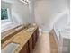 Bathroom with double vanity, granite countertops, and dual soaking tubs at 2507 Oakdale Creek Ln, Charlotte, NC 28216