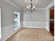 Bright dining room with tile floors and crown molding at 2507 Oakdale Creek Ln, Charlotte, NC 28216